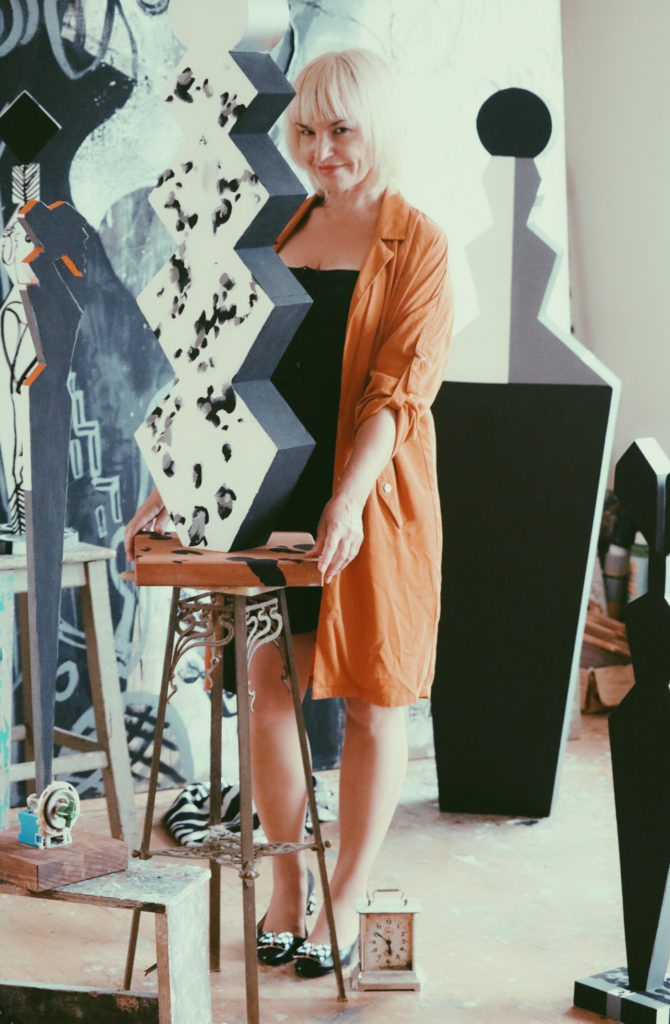 Ieva Caruka and her artwork in the studio.